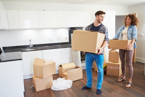 Removalists navigating furniture through a Finchley property