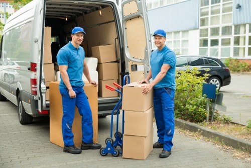 Movers wrapping and protecting furniture for transport in Finchley